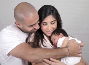 young parents with sleeping baby