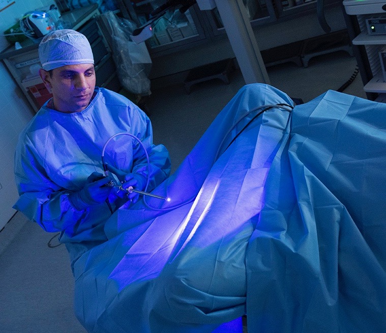 Joseph Jacob, MD, demonstrates Blue Light Cystoscopy. Bladder cancer is the fourth most common cancer in American men, but it’s less common in women. The most common symptom is blood in the urine, which is never normal. (photo by Susan Kahn)