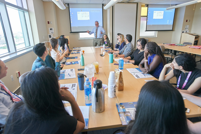 Pediatrics chair Gregory Conners, MD, greets the new pediatric medical residents — all doctors who began three years of training at Upstate in July. Seated next to Conners is pediatric hematologist/oncologist Gloria Kennedy, MD.  (photo by Chuck Wainwright)