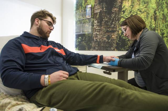 Sam Heckel is prepared by nurse Abby Falconer for one of his 12- to 16-hour infusions of plasma at Upstate. (photo by Richard Whelsky)