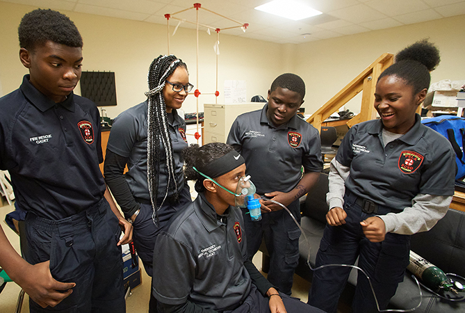 Learning to administer a breathing treatment is important — and fun — for these future emergency medical technicians.