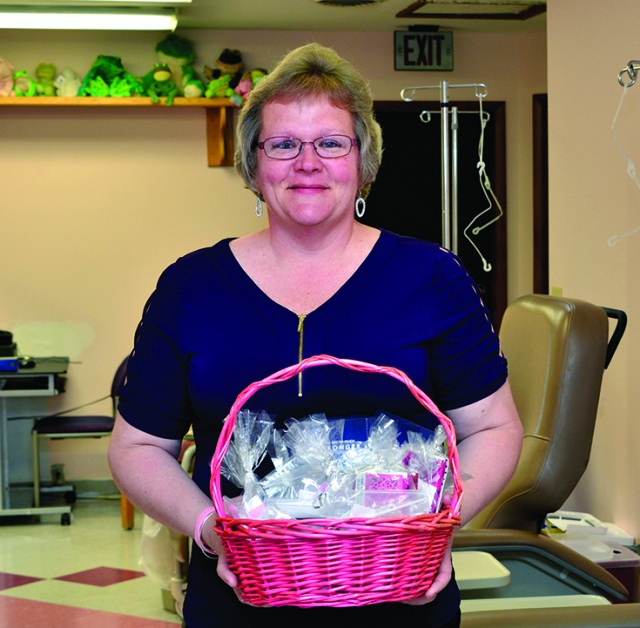 Jacqueline Rose with a basket of earrings (photo by Debbie Rexine)