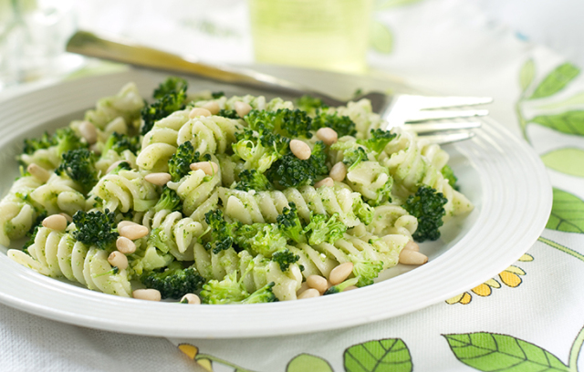 Fresh pasta with broccoli, pesto and pine nuts, selective focus