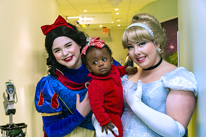 Nine-month-old Maryangeliz Rodriguez, of Syracuse met Snow White and Cinderella during her brother Michael’s appointment at Upstate’s Waters Center for Children’s Cancer and Blood Disorders.