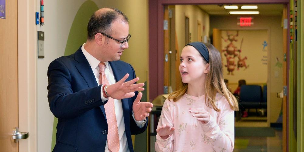 Prateek Wali, MD, encourages his patient Ava Acker to manage her own medication and diet. Wali is a pediatric gastroenterologist at Upstate. (photo by William Mueller)