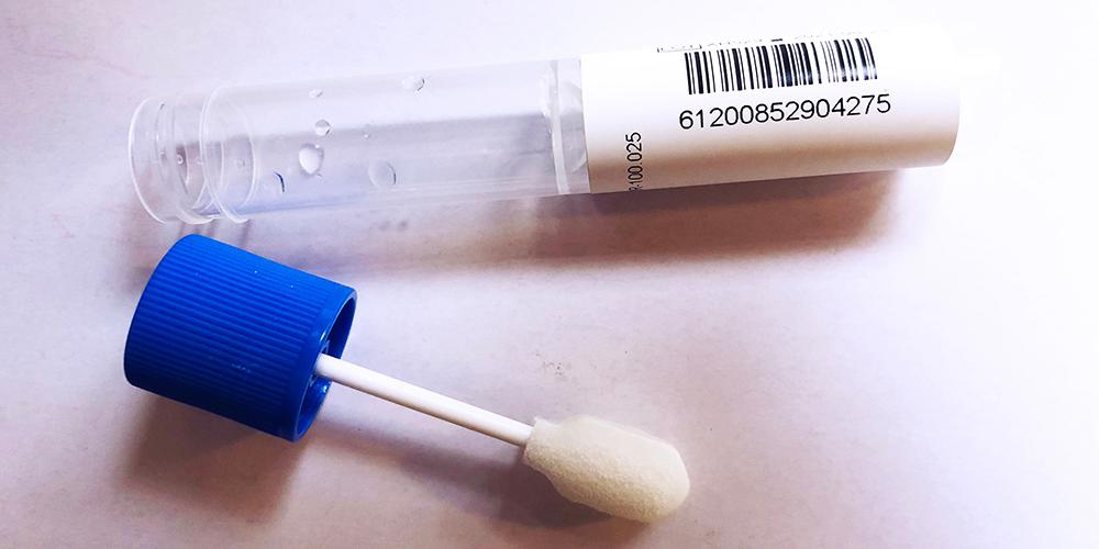 A Clarifi test kit, showing the swab and tube used to collect saliva.