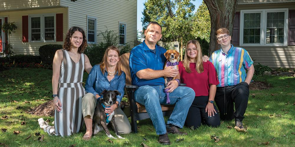 After their COVID-19 crisis, Bill Croft and his wife, Melissa (both holding dogs), gathered at their Geddes home with their children, from left, Elizabeth Croft, Lynda Croft and Arden Croft. (photo by Robert Mescavage)