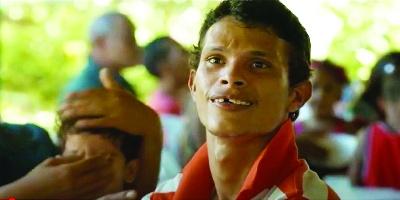 This young Dominican man appears in “Tough as Iron,” a short documentary on PKAN. People with PKAN can often fall, leading to broken teeth.