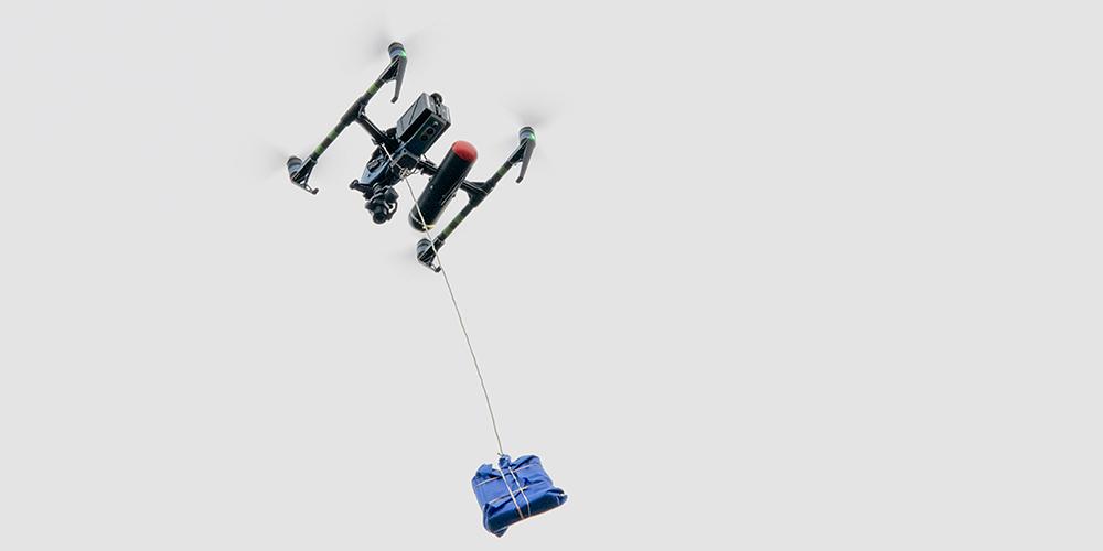 A drone delivering a package during a test run that Upstate took part in earlier this year. (photo by Upstate medical photography staff)