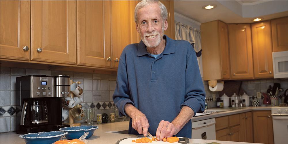 Donald Gregory says of his battle with prostate cancer: “I survived it. It wasn’t easy. It was uncomfortable, but it gets better with time.” He is shown in the kitchen of his Camillus home. (photo by Susan Kahn)