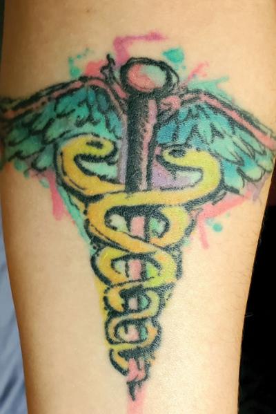 Alyssa Bittel shows pride in being a medical professional with a tattoo of a caduceus, a traditional symbol of medicine.