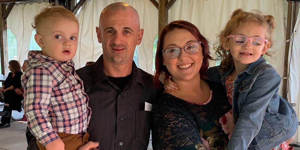 Natalie Baumgartner, who has been treated for cataracts and glaucoma at Upstate, is held by her mother, Ryan Earl, at right. At left are Natalie’s father, Patrick Baumgartner, and her brother, Damon. (provided photo)
