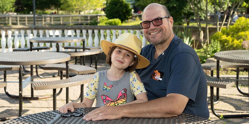 Vince Lumia, shown with Tara, his granddaughter, performed as DJ for National Cancer Survivors Day 2022 at the Rosamond Gifford Zoo at Burnet Park in Syracuse. (photo by Susan Kahn)