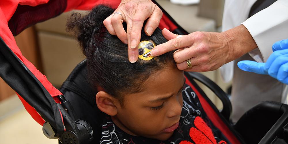 Juju receives medication through a port (under the yellow sticker) into his brain.