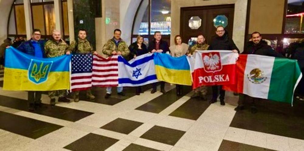 The team was presented with flags of Ukraine, the U.S., Israel, Poland and Mexico. Nikolavsky is at left, Bratslavsky fourth from left.  The Ukrainian flags were signed by patients and a Ukrainian general.