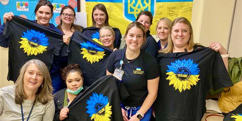 Upstate urology department staff members show the "We Stand With Ukraine" T-shirts they designed and are selling to raise funds for the Ukraine1991 Foundation.