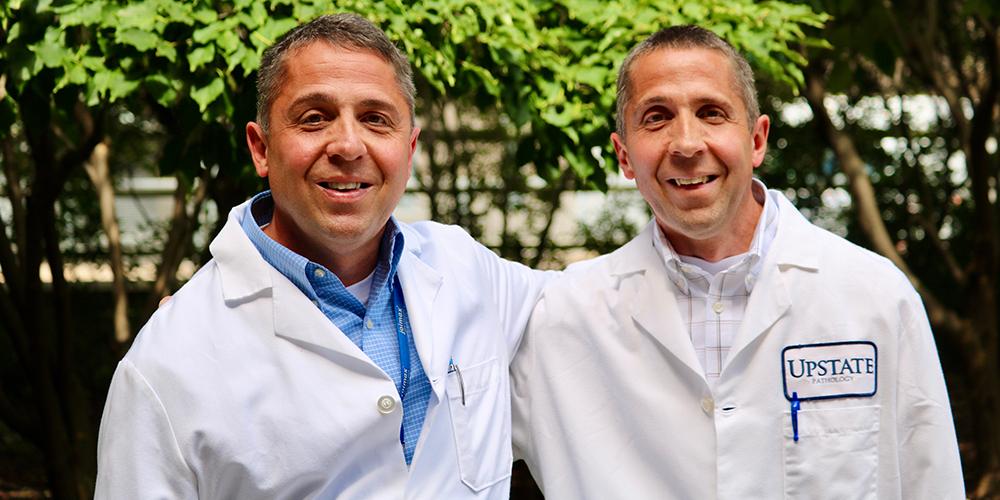 Daniel, left, and Donald Jaeger can cover for each other in their jobs with the anatomy laboratory/anatomical gift program and the autopsy service. People often mistake one brother for the other.  Photo by Jim Howe.
