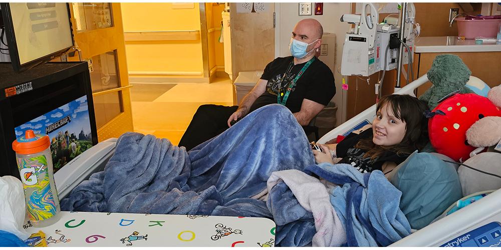 Brad Taylor, a gaming and technology specialist, plays video games with Savannah "Savvy" Spittler, a patient at the Upstate Golisano Children's Hospital. Provided photo